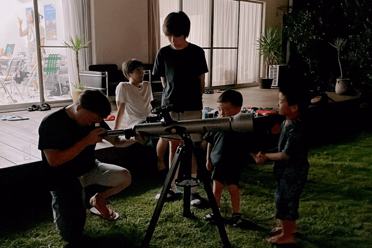 Children looking through a telescope