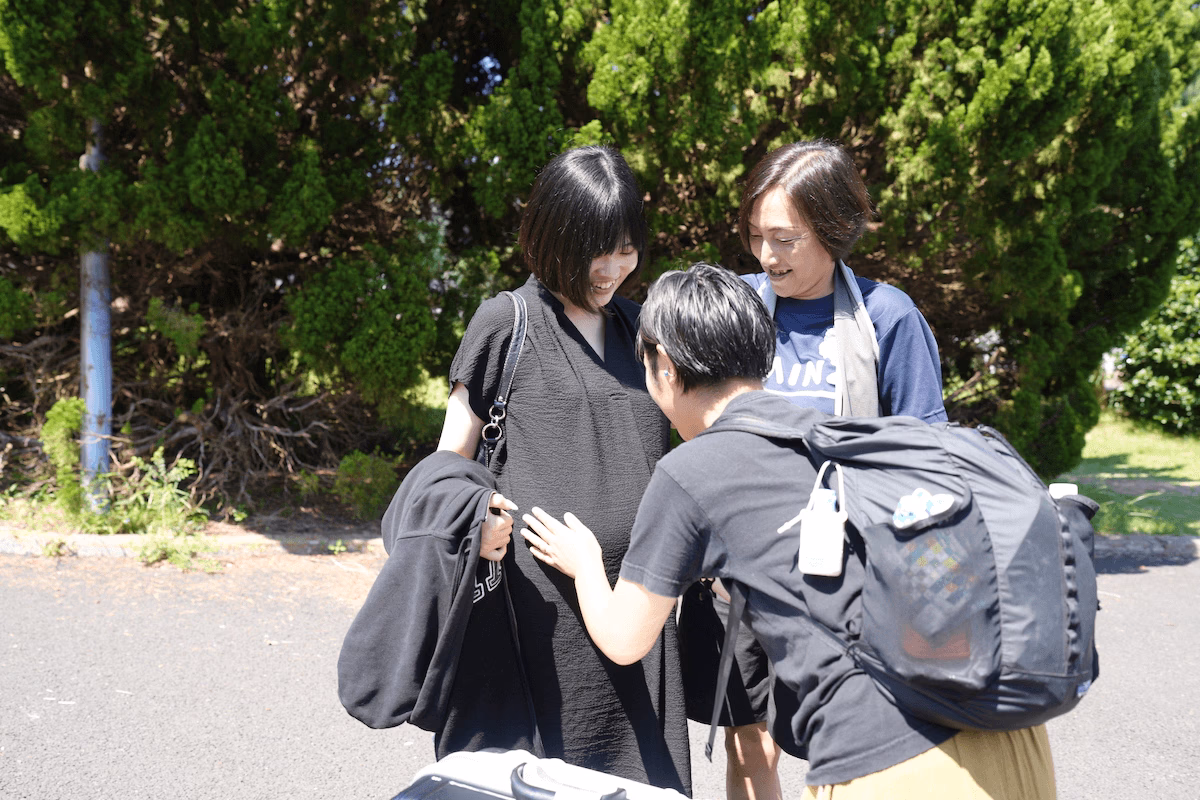 Two people surrounding Mr. Morino
