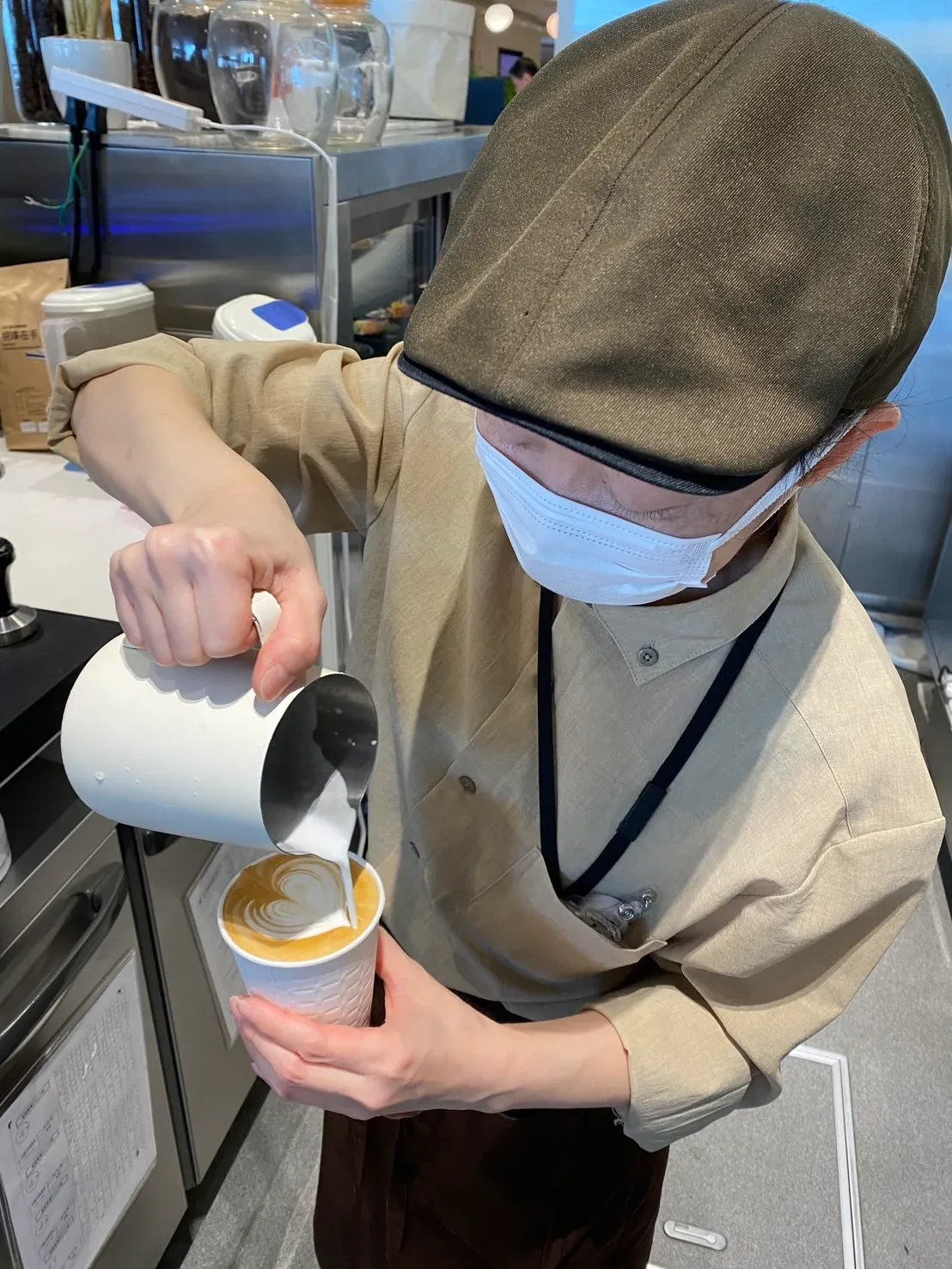 A photo of Ms. Tobari making heart-shaped latte art.