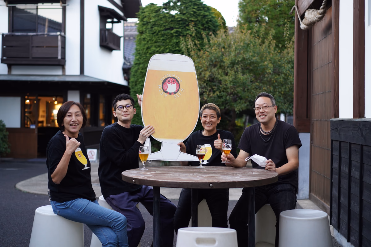 Four people laughing with beer